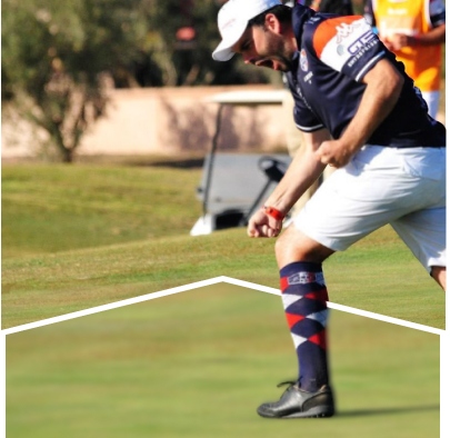 A player celebrating on the field as others watch in the background.