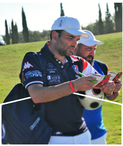 Close-up of two men reviewing scorecards on a golf course.