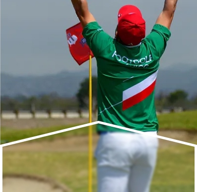 A man in green, red and white sportswear celebrating near the hole.