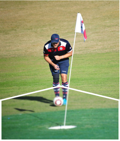 A player is about to kick the ball toward the hole.
